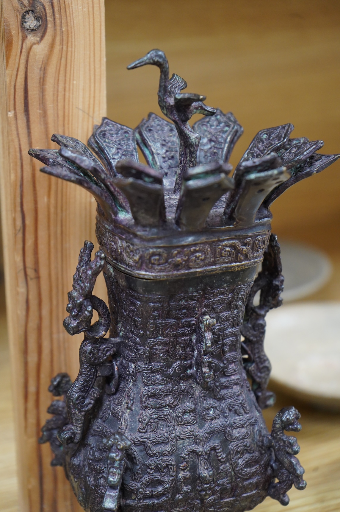 A Chinese Shang style bronze vessel and cover, 23cm